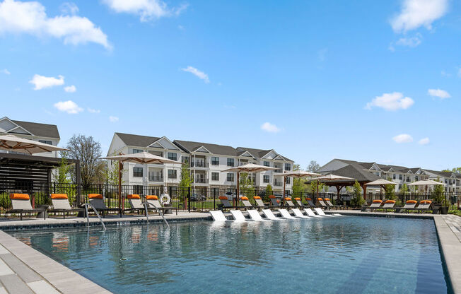 A large swimming pool with lounge chairs and a resort-style building in the background at Madison Prickett Preserve, Yardley, PA
