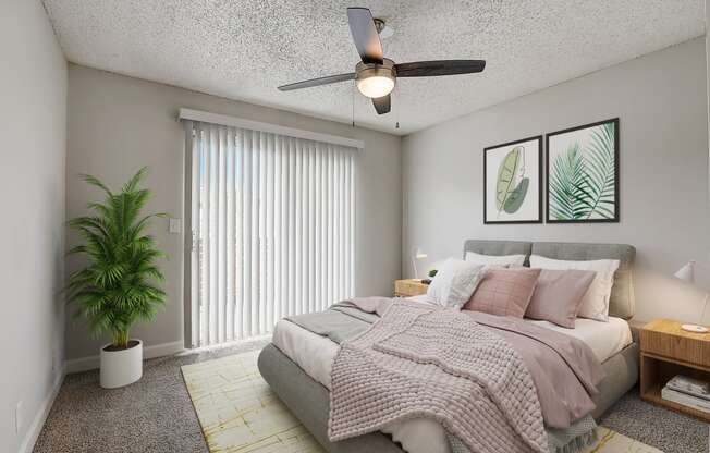 a bedroom with a large bed and a ceiling fan