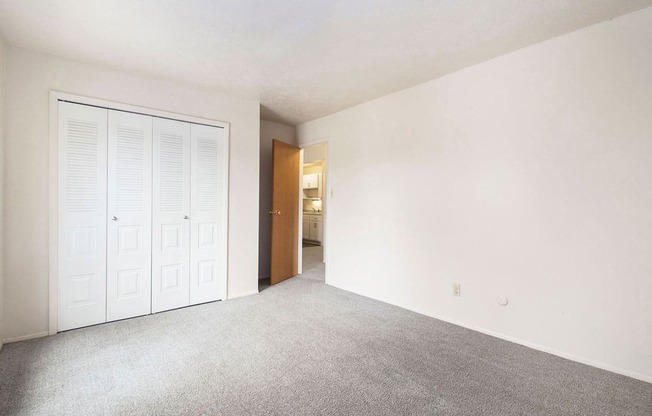 an empty bedroom with a large closet