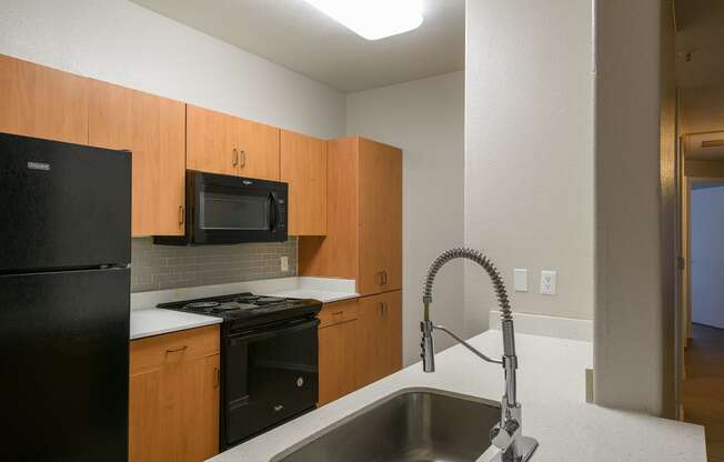 a kitchen with a sink and a stove and a microwave