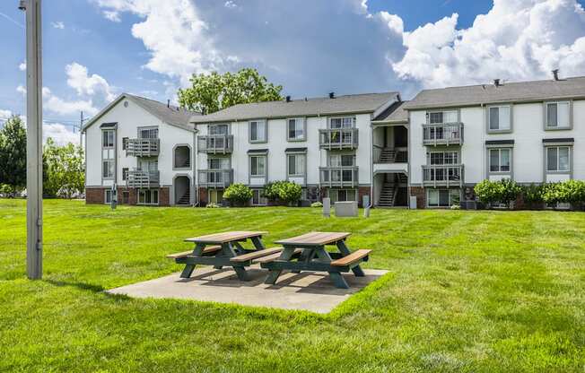 A picnic table is in front of apartment buildings