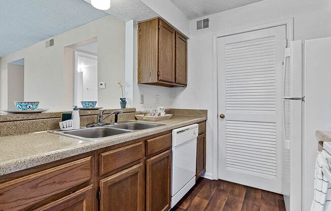 a kitchen with a sink and a refrigerator