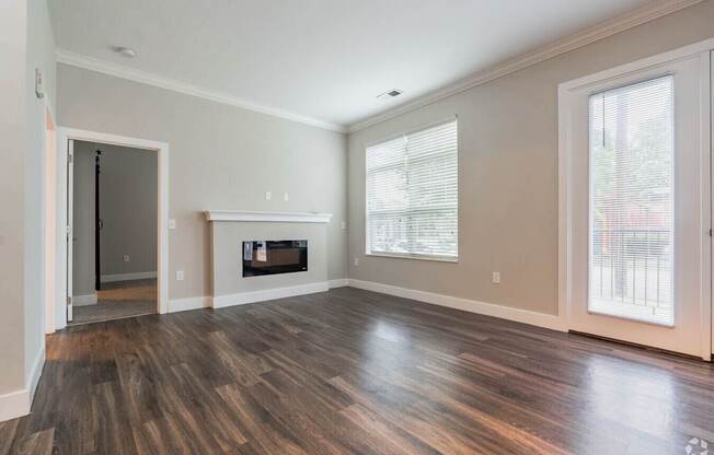 A room with a fireplace and wood flooring.at Century Baxter Avenue, Louisville, KY 40204