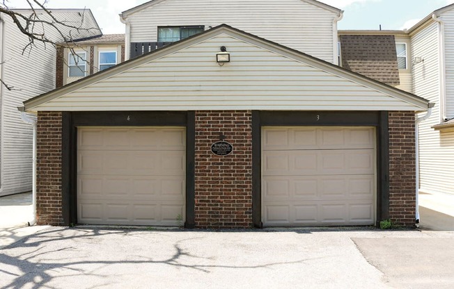 two garage doors on the side of a house