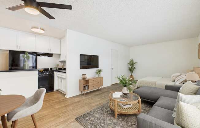 A kitchen with a refrigerator, oven, and microwave.