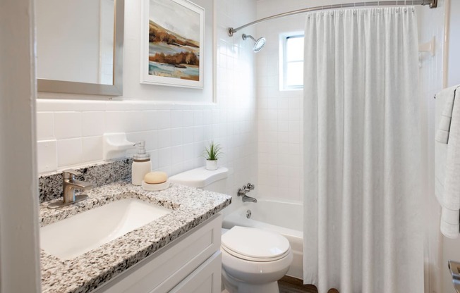 a bathroom with a sink and a toilet and a shower at Venue at Carrolton in Carrolton, GA 30117