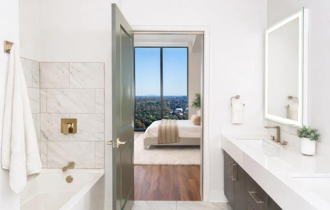 Penthouse bathrooms feature clean-lined finishes, generous vanities, and sightlines that open to sweeping views.