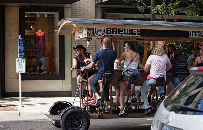 group of people pedal biking on booze tour through city at The Wyatt, Portland, Oregon