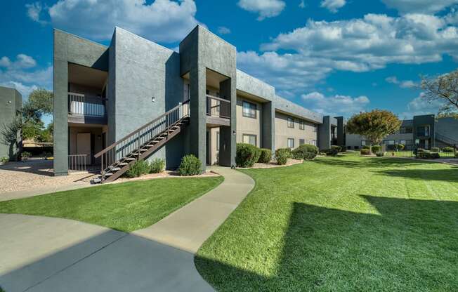 A modern building with a green lawn in front.