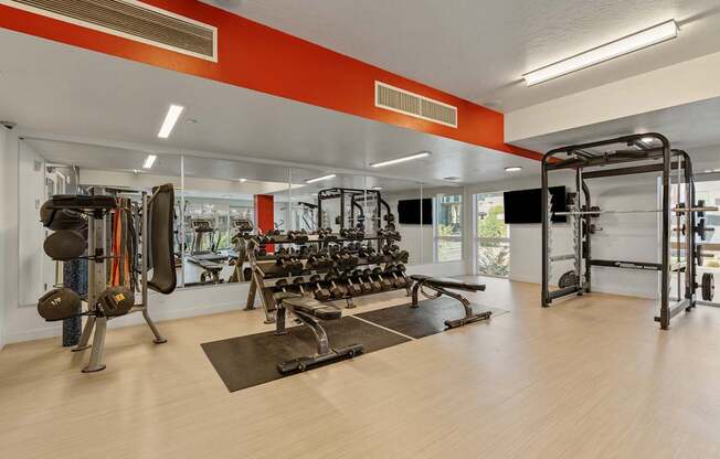 a fitness room with weights and cardio equipment at the apartments