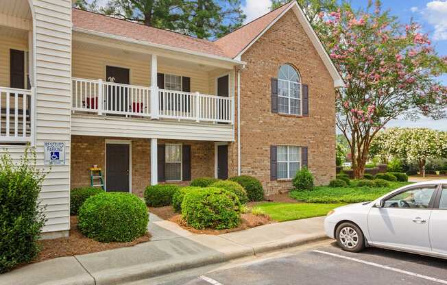 a white car parked in front of an apartment building