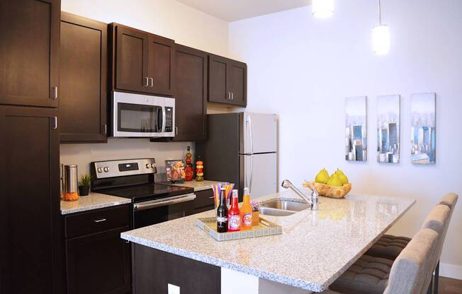 A kitchen with a granite countertop and a white refrigerator.