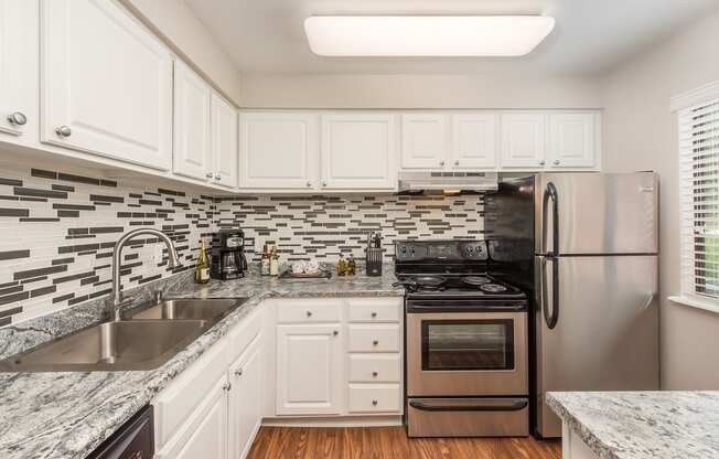 kitchen with white cabinets  at Lodge of Overland Park Apartments, Overland Park