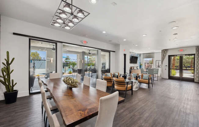 A large dining room with a wooden table and chairs.