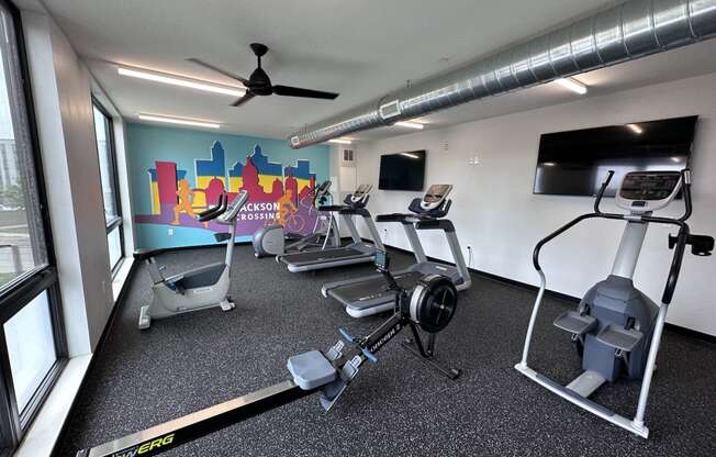 Modern gym with rows of cardio equipment.