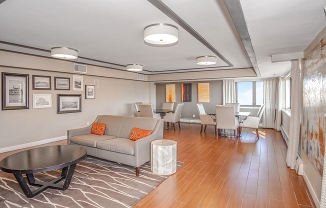 a living room with a couch and a table with chairs