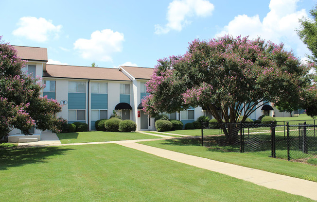 lush courtyard with sidewalk, fenced dog park, and lush landscaping at Sherwood Park Apartments  at Huntsville Landing Apartments, Huntsville