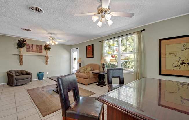 a dining room and living room with a table and chairs