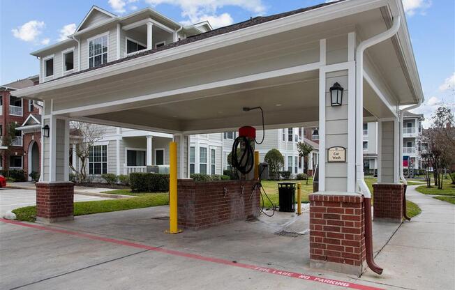 an empty gas station with a building in the background at Volare at the Woodlands, The Woodlands, Texas