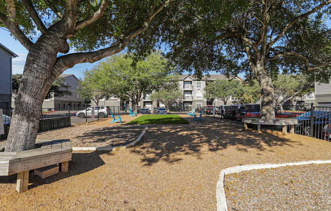 A playground with a white line on the ground and a tree in the background.