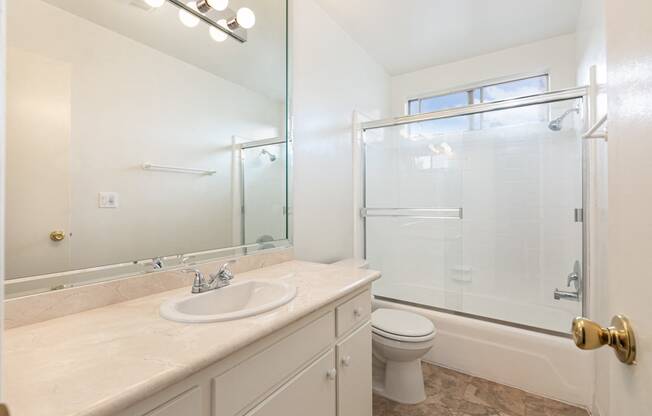 Bathroom with White Cabinets and Bathtub/Shower