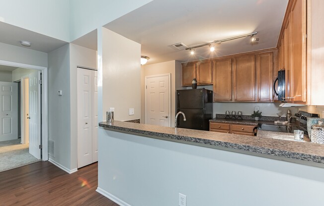 Elevate your lifestyle at Eagle Rock Apartments at Columbia. This modern kitchen features sleek granite countertops, stainless steel appliances, and ample space for culinary creativity. Envision your new home today—schedule a tour!