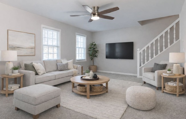A living room with a grey couch, a coffee table, and a television.