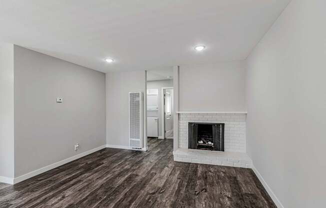 A room with a fireplace and a mirror on the wall.