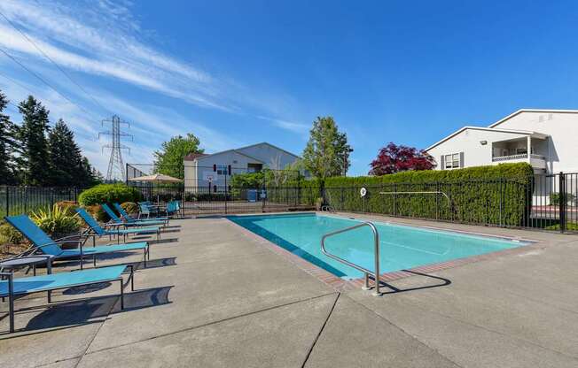 Community Swimming Pool with Pool Furniture at Landings at Morrison Apartments located in Gresham, OR.