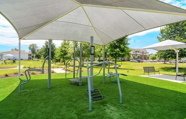 a playground at a park with swings and benches