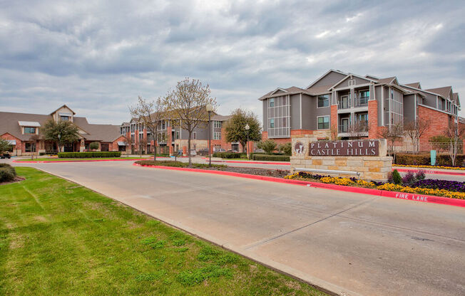 an empty street in front of an apartment building at Platinum Castle Hills, Lewisville, Texas