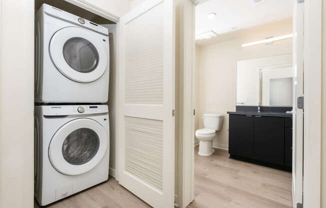 A white washing machine and dryer in a small laundry room.