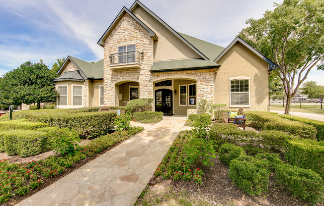 View of Building Exterior, Showing Leasing Office and Landscaping at Stonebriar of Frisco Apartments