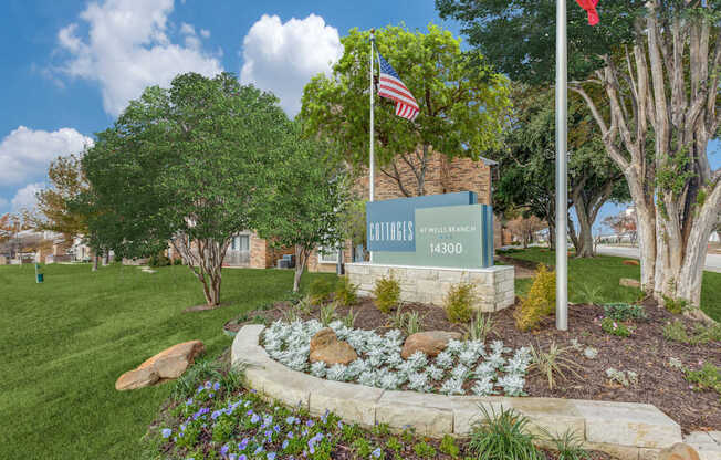 A sign for Bullfrog Creek Estates is in front of a green lawn.
