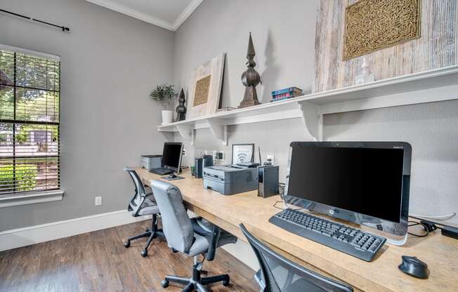 an office with a desk with a computer on it