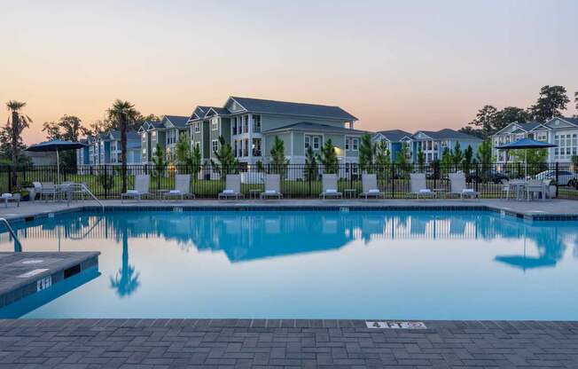 A swimming pool in front of a building with a number 133 on the ground.