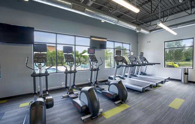 A gym with treadmills and elliptical machines.