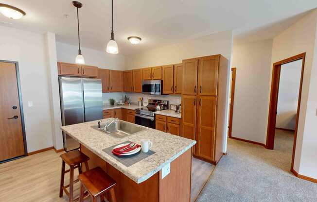 a kitchen with wooden cabinets and a granite counter top