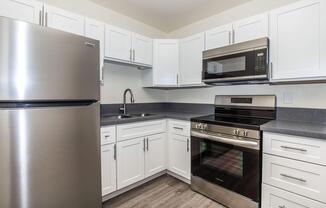 a kitchen with a stove and a refrigerator