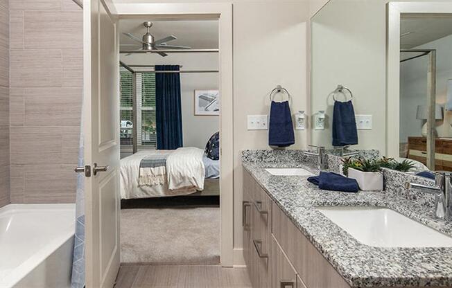 a bathroom with a tub and a sink and a mirror at Promenade at Newnan Crossing, Newnan, 30265