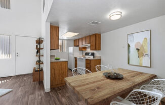 Model Kitchen with Wood-Style Flooring at District at Fiesta Park Apartments located in Mesa, AZ.