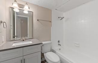 a bathroom with a sink toilet and bathtub