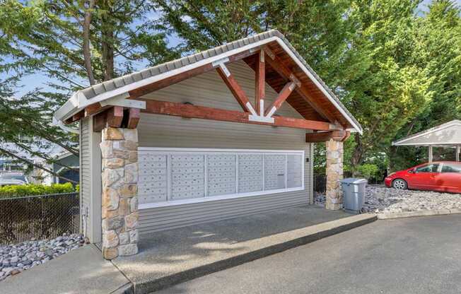 A covered mailbox area with a wooden roof at Abbey Rowe Apartments in Olympia, WA