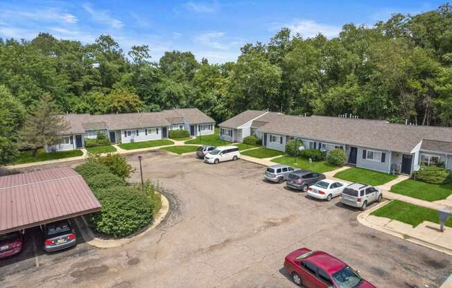 an aerial view of a parking lot and houses