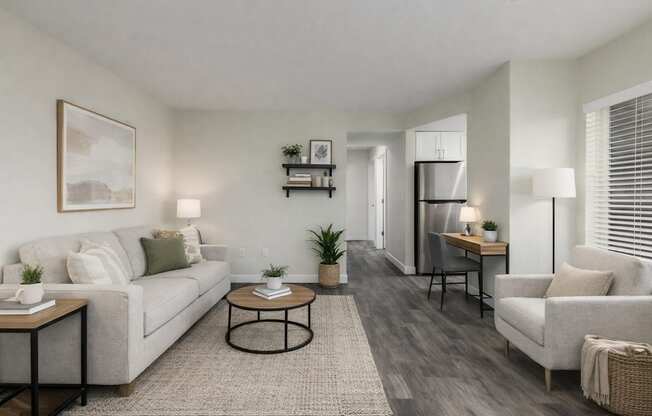 A living room with a grey couch, a coffee table, and a chair.