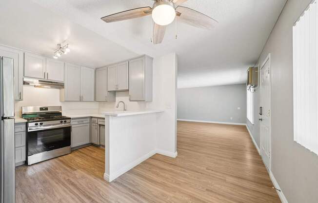 A kitchen with a view of the living room