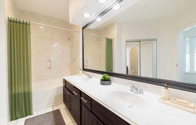 a bathroom with two sinks and a large mirror