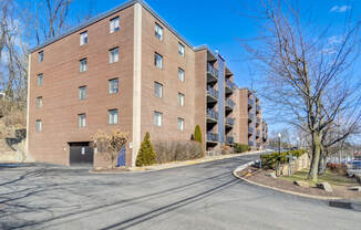 a large brick building with a street in front of it