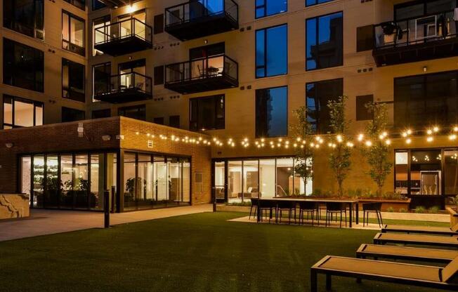 Outdoor courtyard at night with cafe lighting