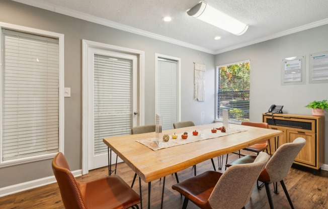 a dining room with a wooden table and chairs     and a piano